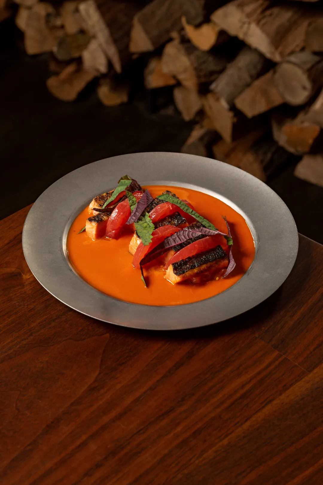 Grilled coho salmon in a chili broth with shaved fennel