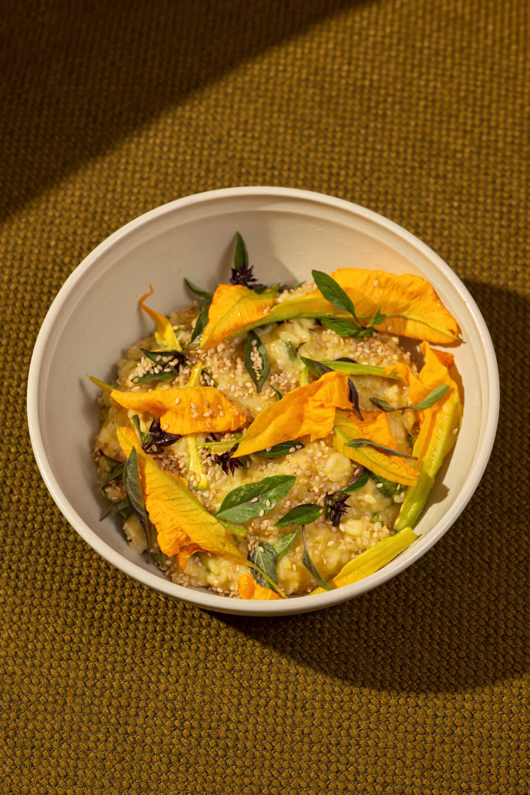 Risotto with squash blossoms, sesame, and basil