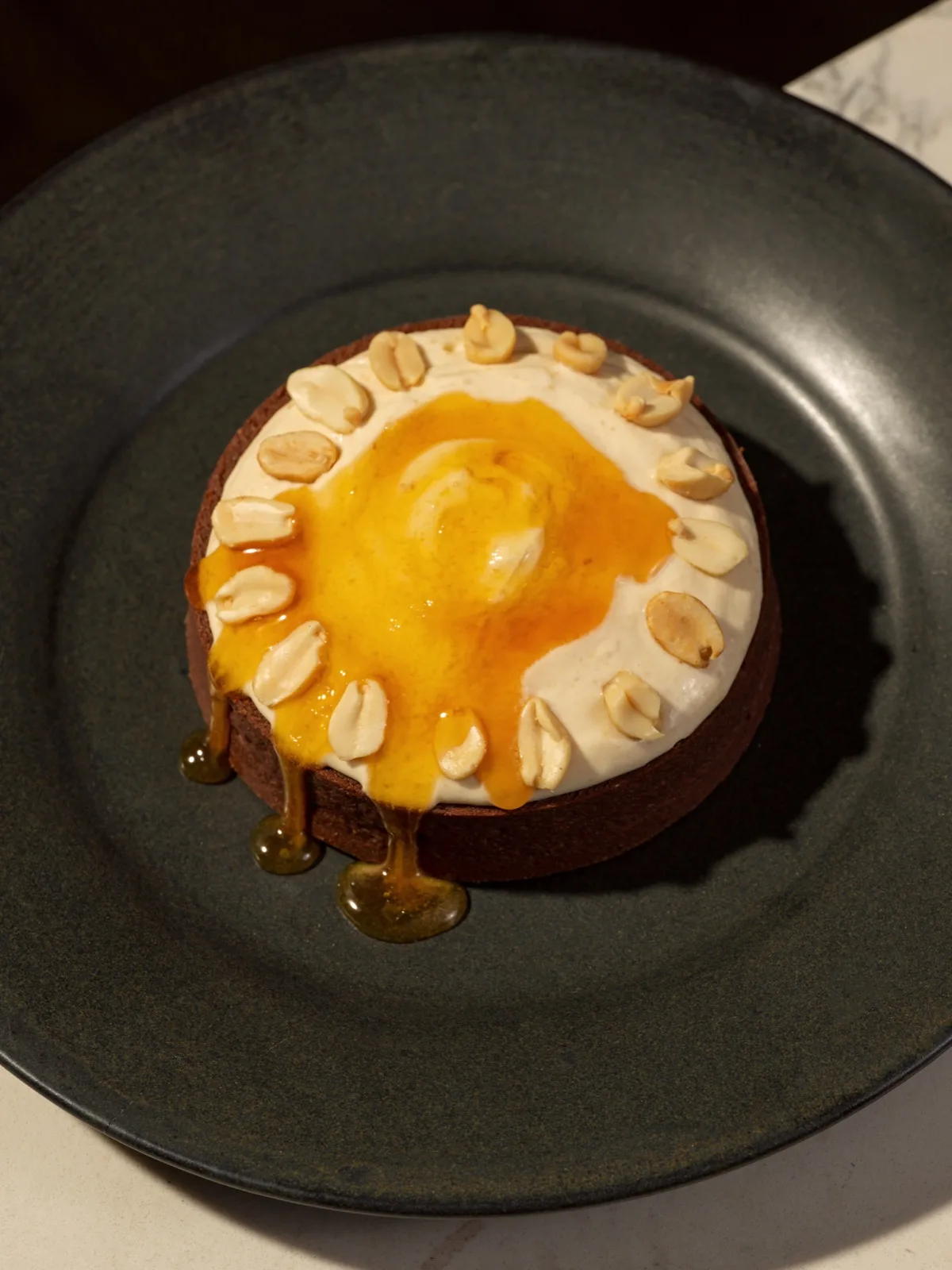 A peanut tart with cream and warm caramel