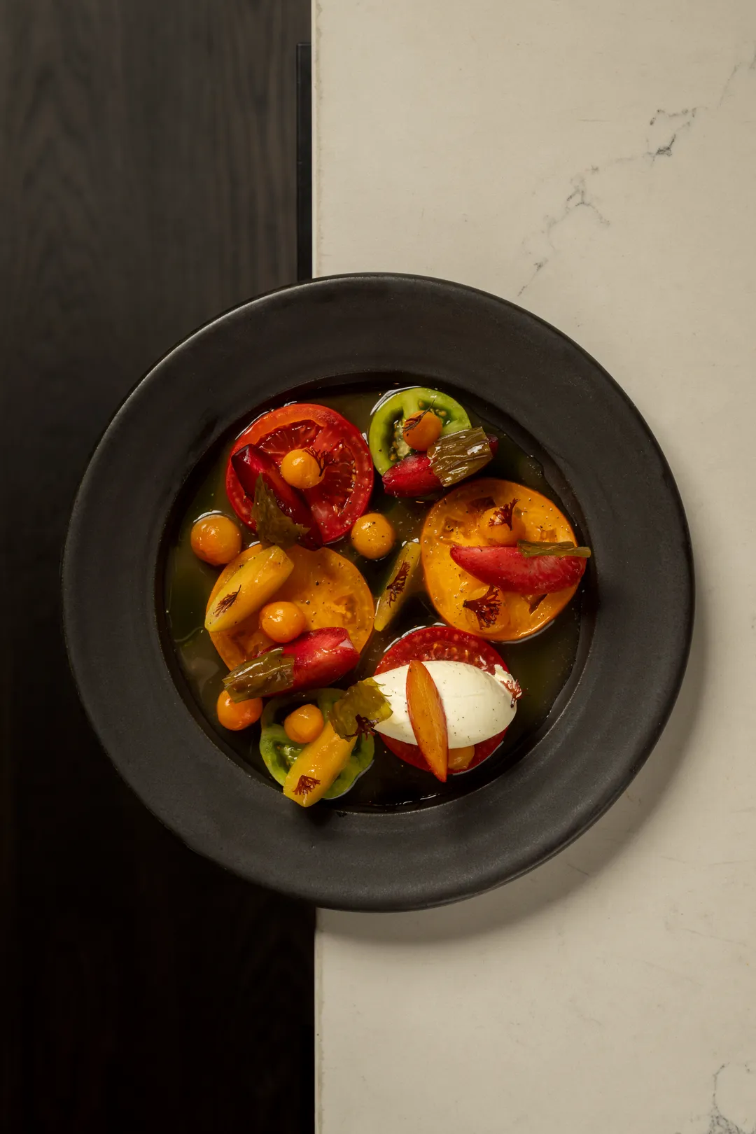 Tomato and stone fruit salad with fresh cheese and seaweeds