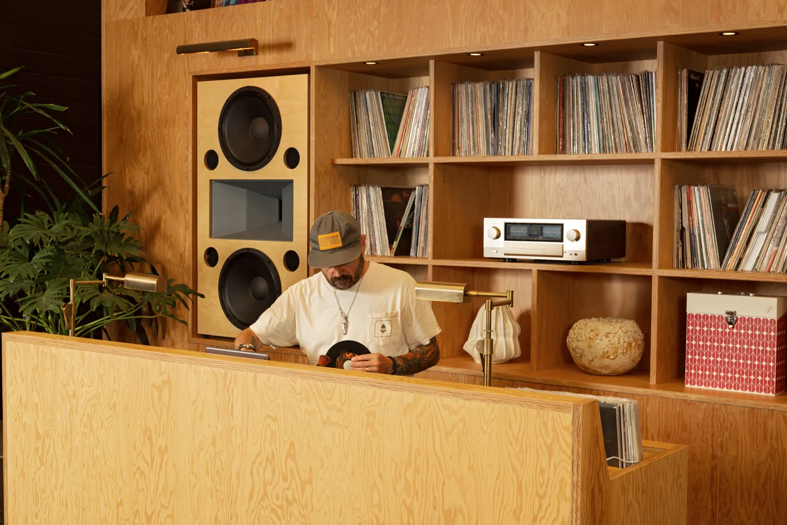 Sean Brock examining a 45 at the hi-fi listening wall