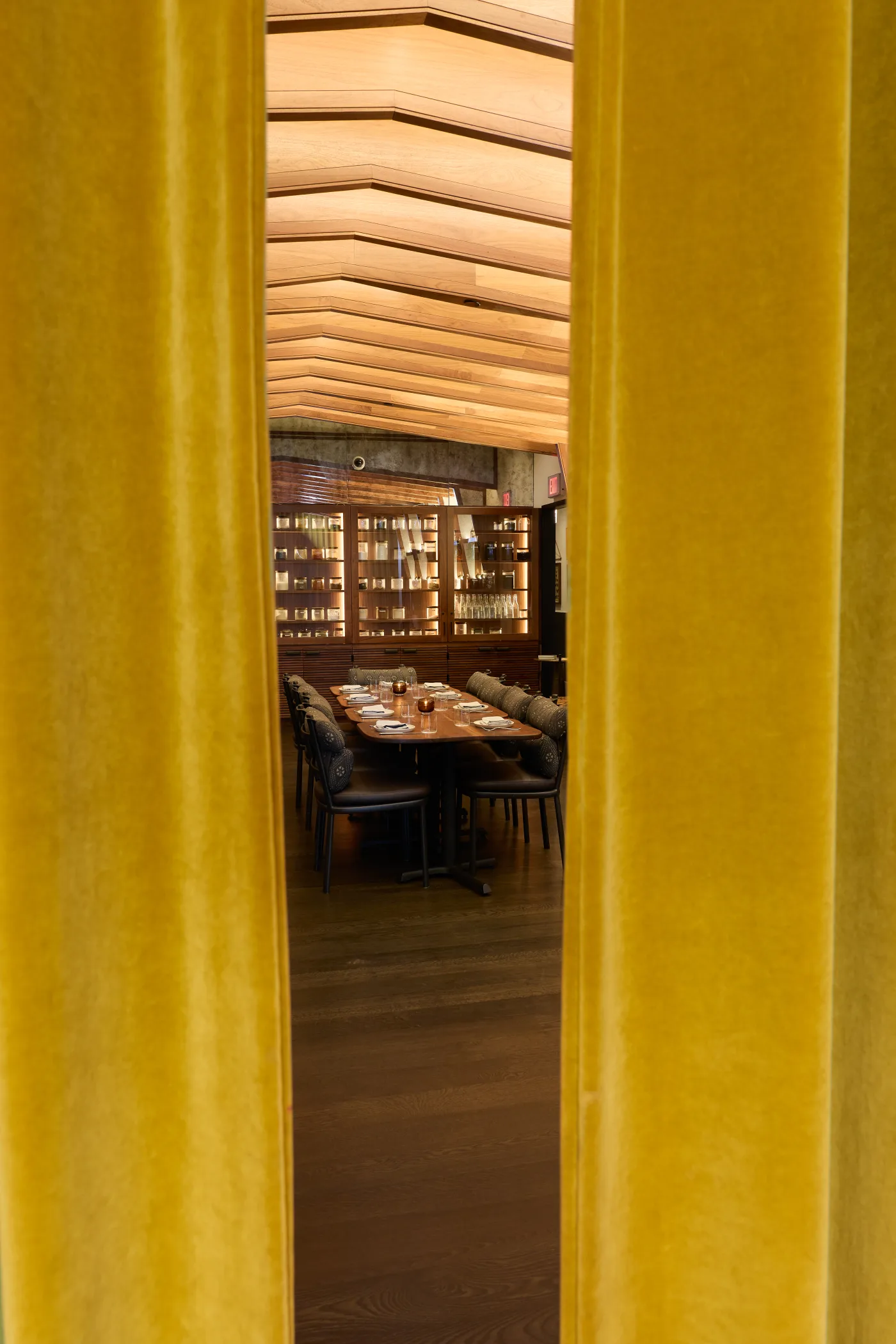 The private dining room at Darling glimpsed through a gap in the mustard velvet curtain